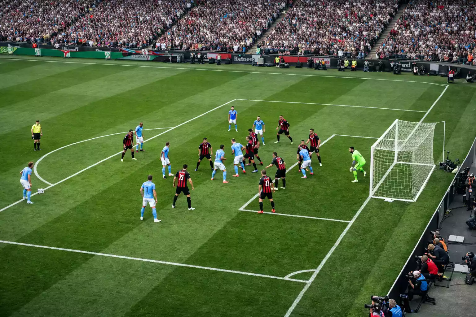 Aerial view of a football set piece with players positioned in the penalty box